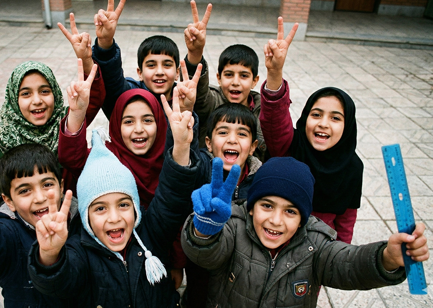 Group of smiling school children giving peace signs