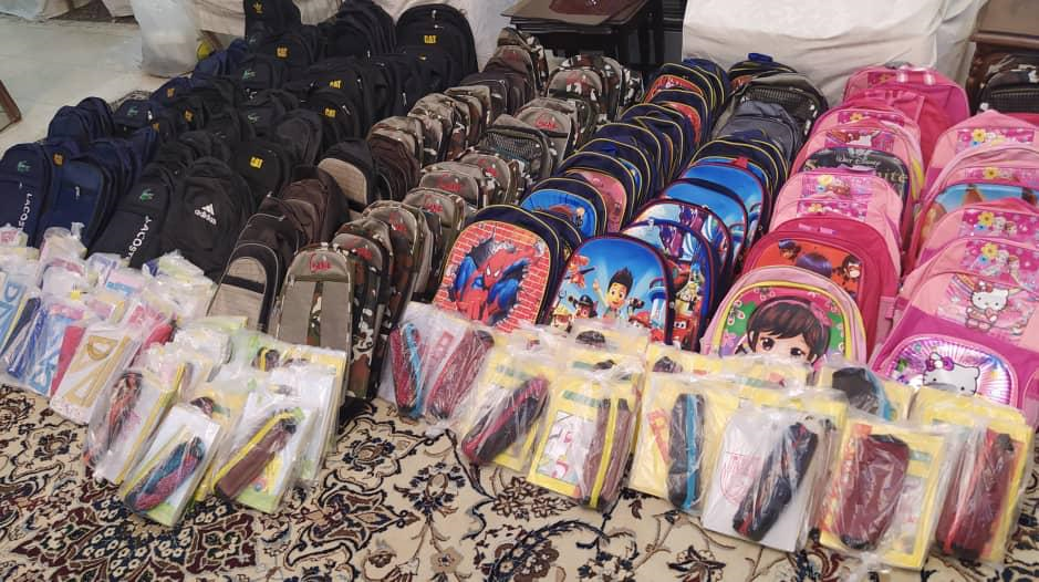 Children receiving backpacks and school supplies